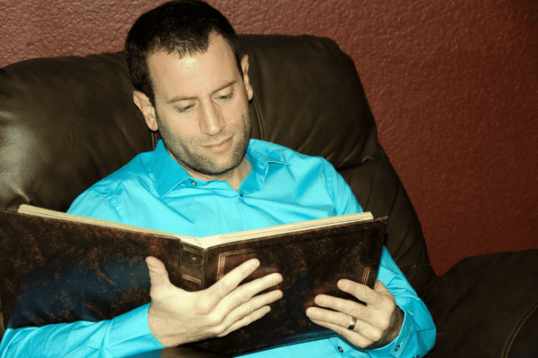 A photo of a man viewing a photo album