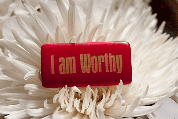 Photo of flower with ''I am worthy'' written