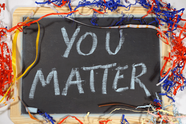 You Matter written on a black slate with color ribbons around its edge.