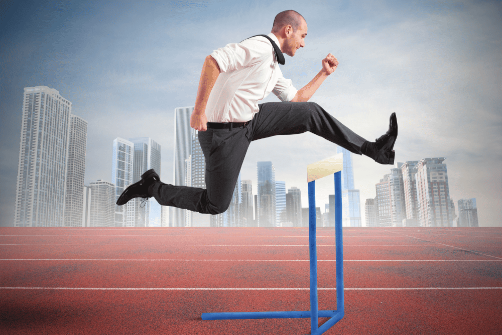 How to Overcome Obstacles to Success.

A man jumping over a hurdle on a track