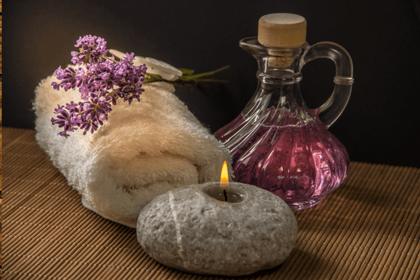 Best Massage for Stress and Anxiety.
towel, oil and lit candle for massage.