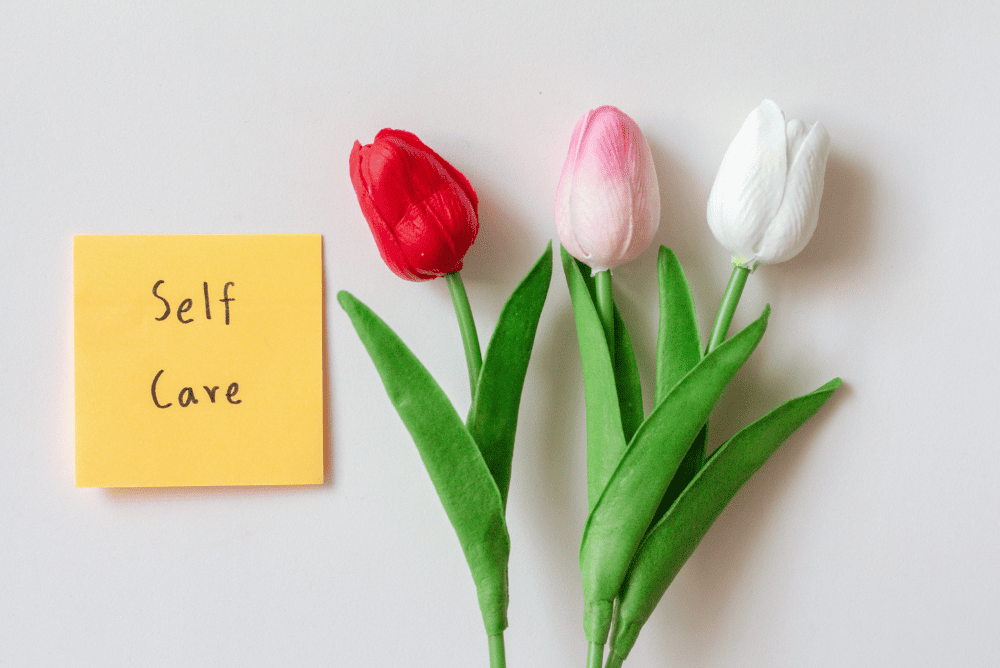 flower and self-care written on a sticky note.