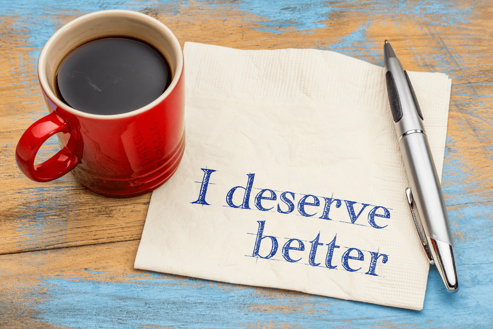 I deserve better written on brown tissue. A mug of black coffee and pen.