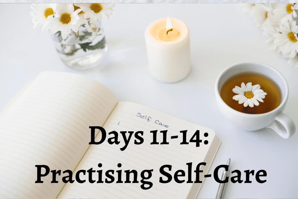 A self-care book opened with candle and cup of tea.