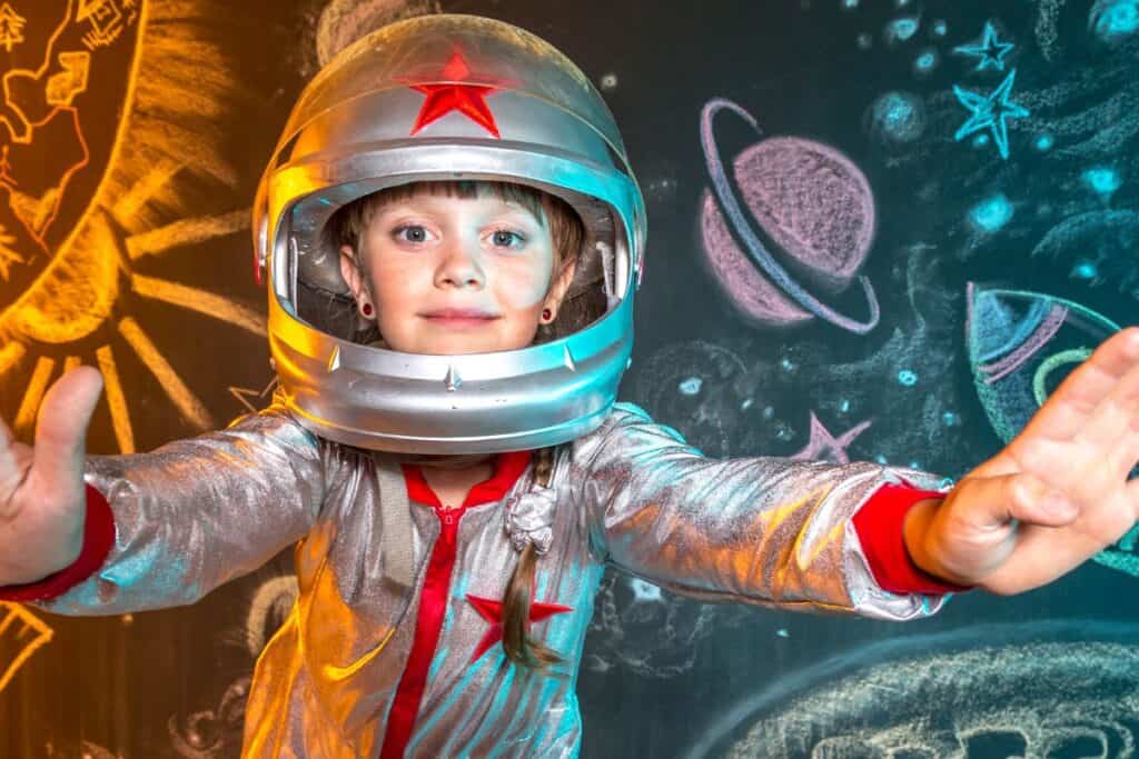 A young boy in a space suit posing for a photo.