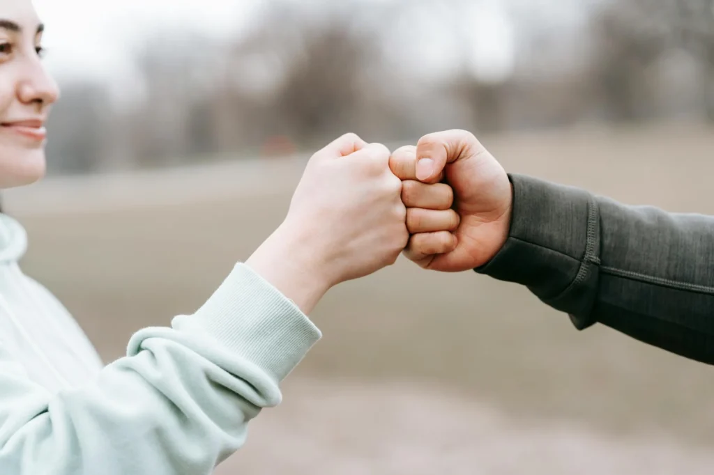 A fist shake from 2 peoples hands.